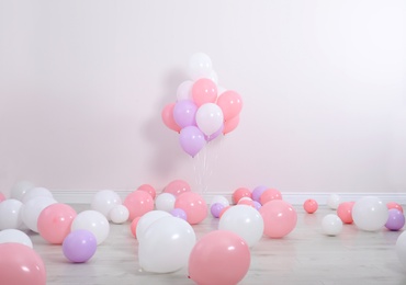 Photo of Room decorated with colorful balloons near wall