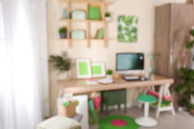 Photo of Blurred view of comfortable workplace with computer at home