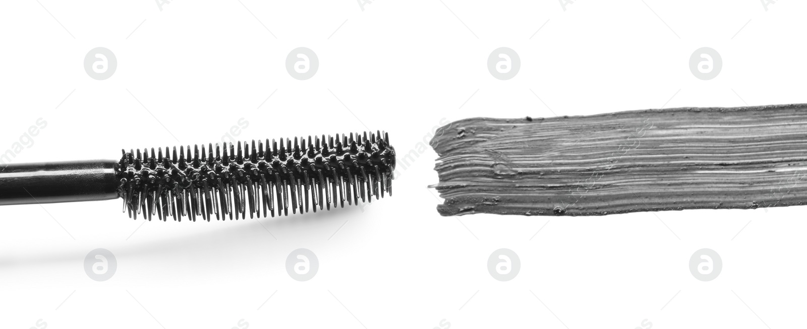 Photo of Smear of black mascara and applicator isolated on white