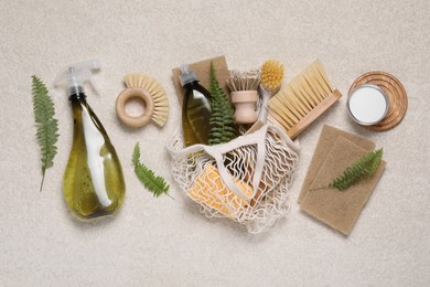 Photo of Flat lay composition with different cleaning supplies on beige background