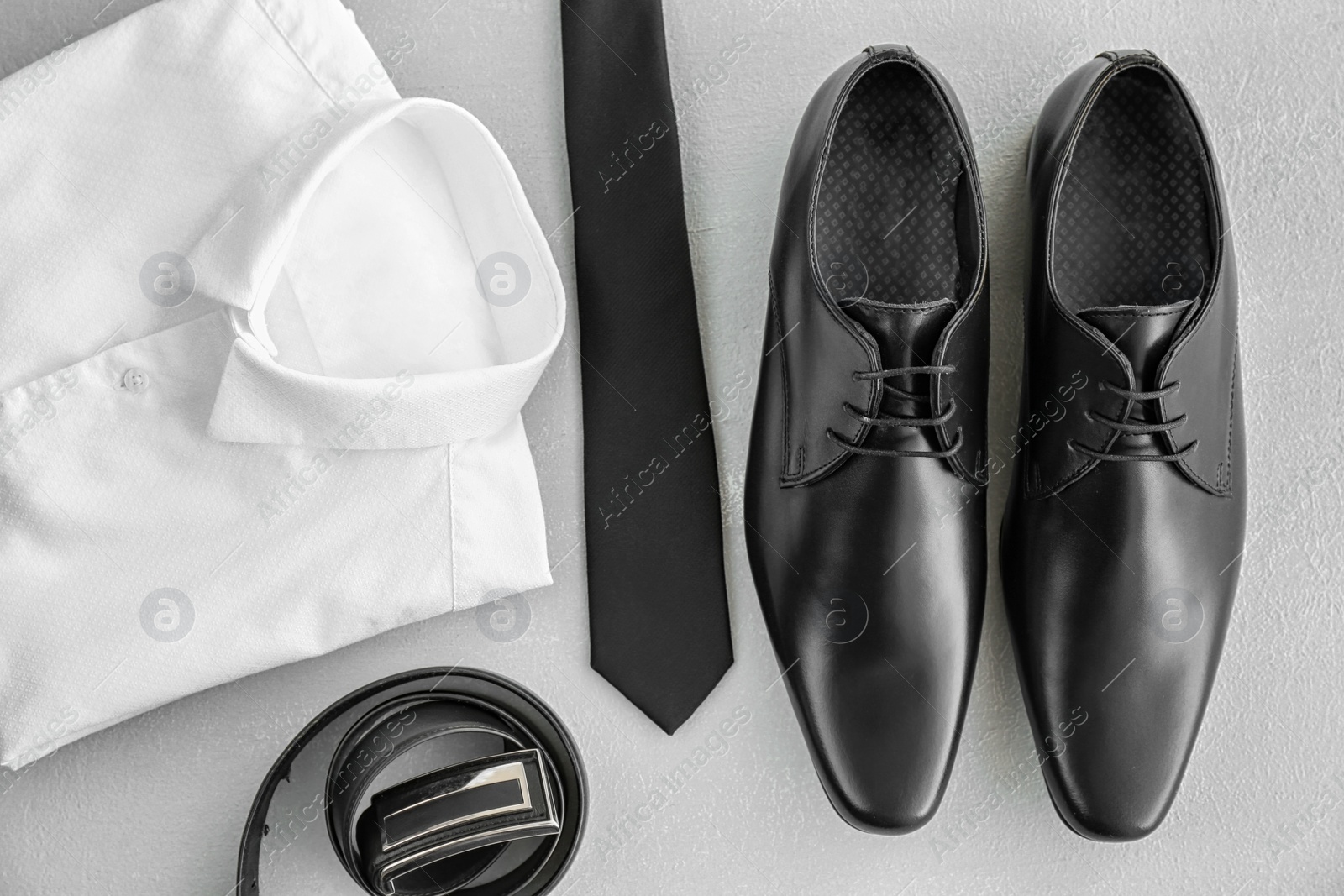 Photo of Composition with elegant male shoes and accessories on light background