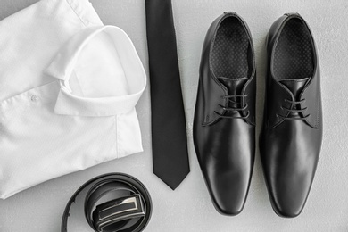 Composition with elegant male shoes and accessories on light background