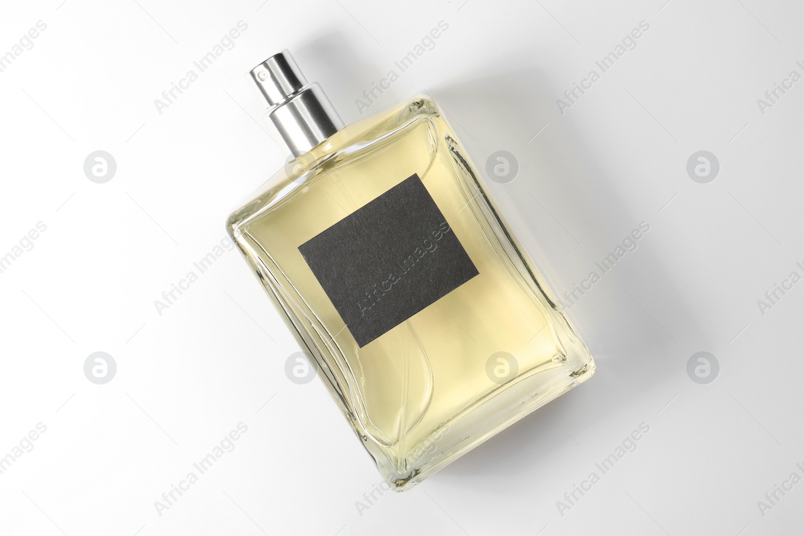 Photo of Luxury men's perfume in bottle on white background, top view