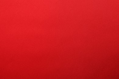 Photo of Texture of red silk fabric as background, top view