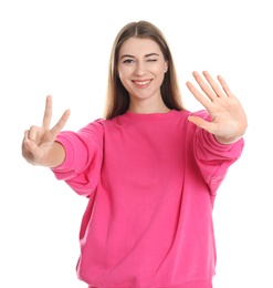 Photo of Woman showing number seven with her hands on white background