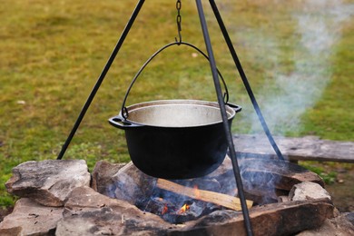 Cooking food on campfire outdoors. Camping season