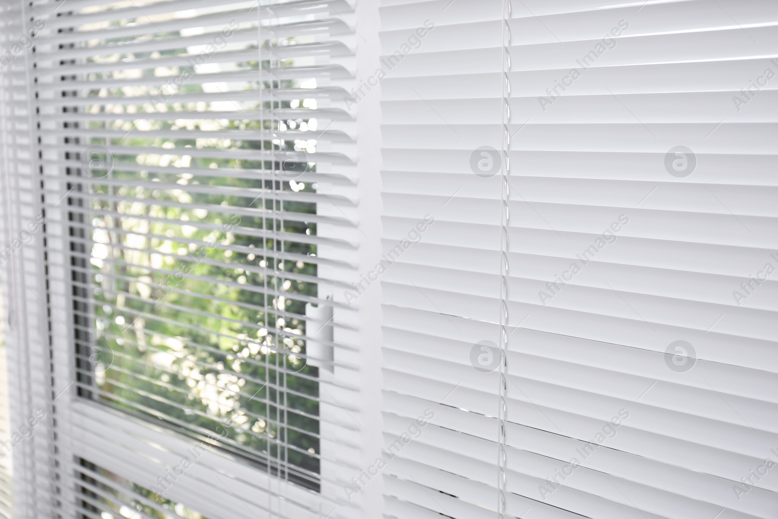 Photo of Window with closed white horizontal blinds as background