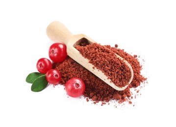 Photo of Wooden scoop with dried cranberry powder, fresh berries and green leaves isolated on white