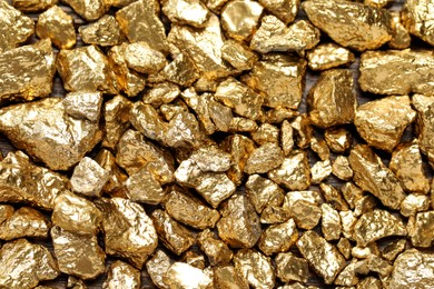 Pile of gold nuggets as background, top view