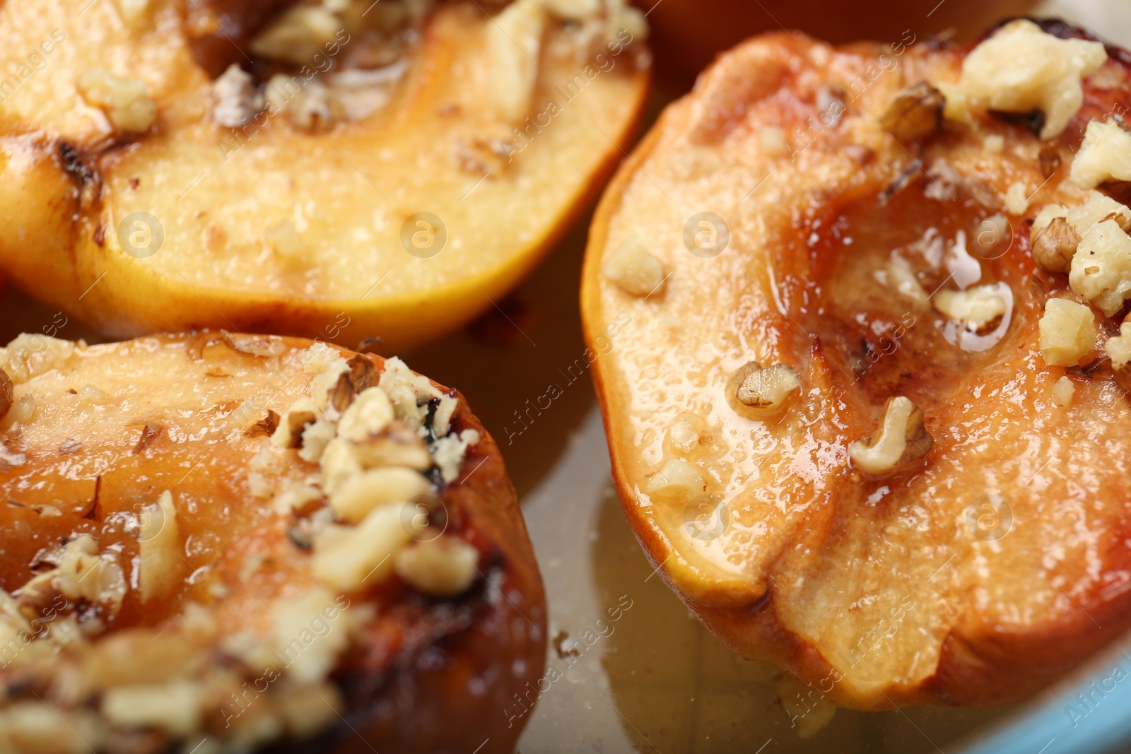 Photo of Delicious baked quinces with nuts and honey, closeup