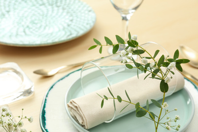 Elegant table setting with flowers and leaves, closeup