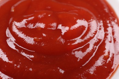 Photo of Delicious ketchup as background, closeup. Tomato sauce