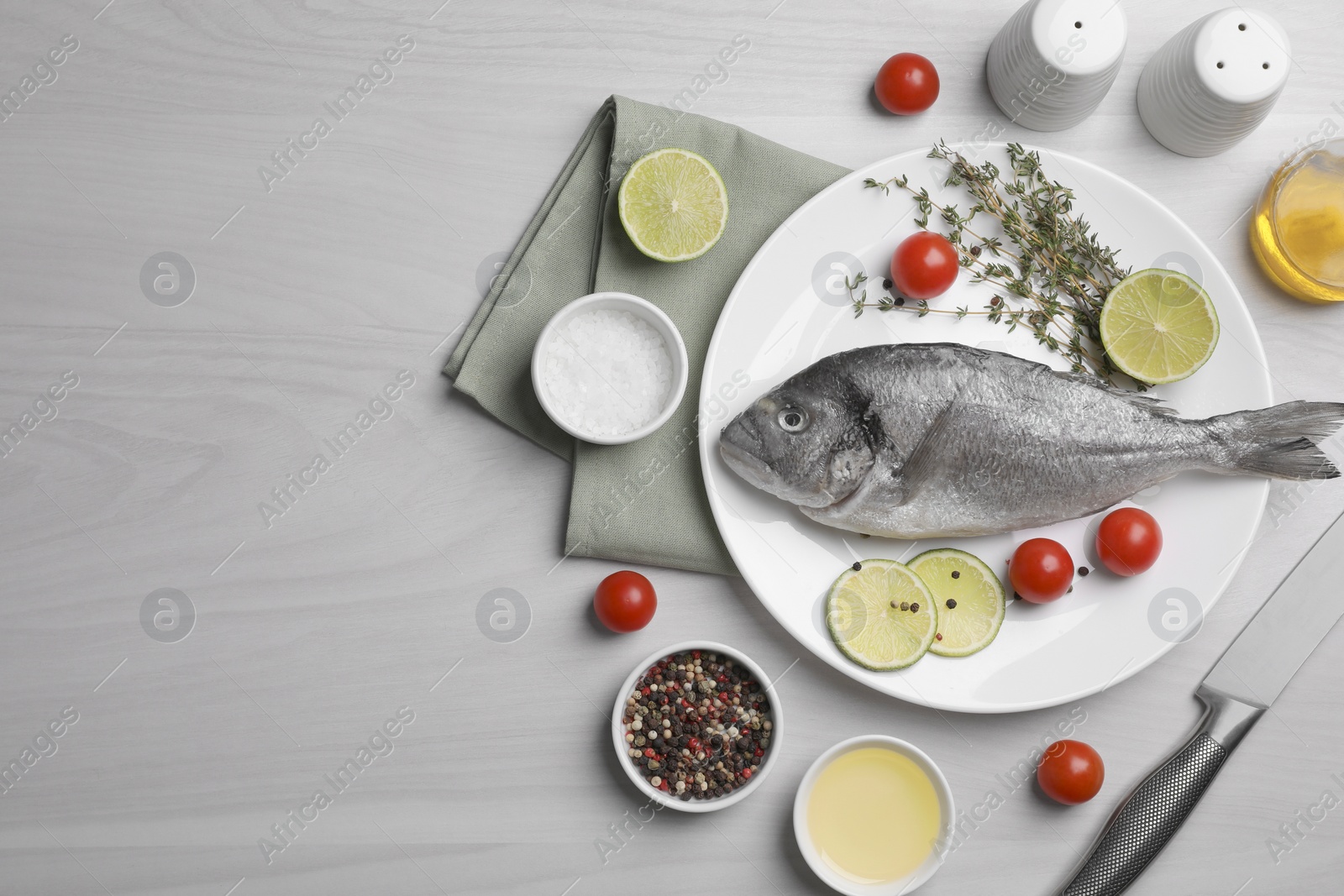 Photo of Flat lay composition with raw dorado fish on white wooden table. Space for text