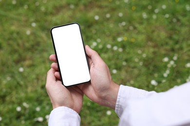 Man using mobile phone outdoors, closeup view