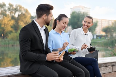 Business people spending time together during lunch outdoors