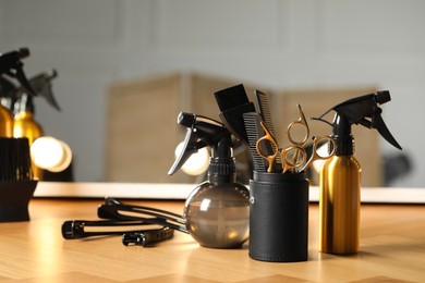 Photo of Set of hairdresser tools on table in salon