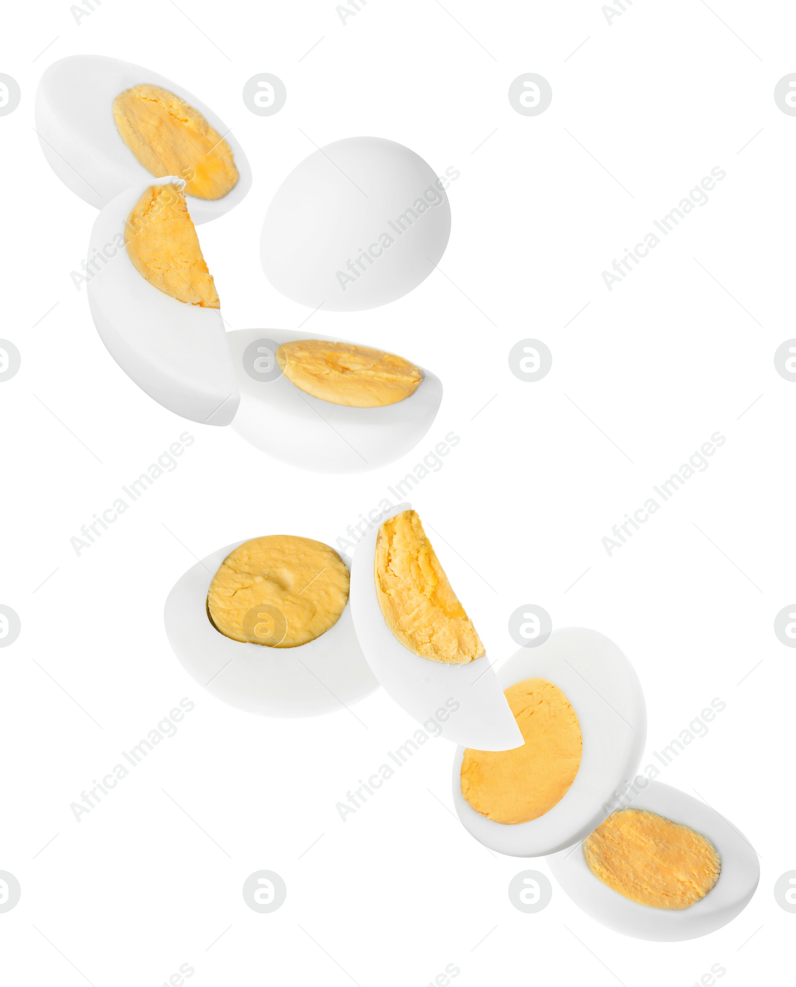 Image of Tasty hard boiled eggs falling on white background