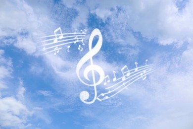 Treble clef and musical notes against sky