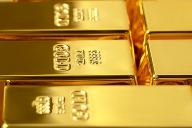Photo of Many shiny gold bars as background, closeup