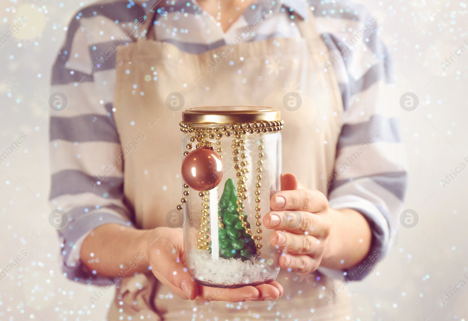 Image of Woman holding handmade snow globe on white background, closeup