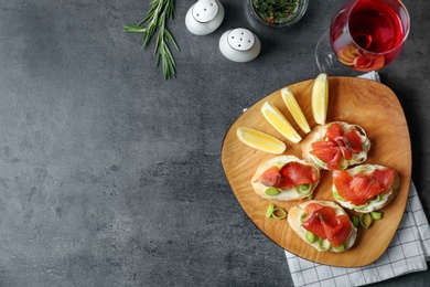 Photo of Sandwiches with fresh sliced salmon fillet on table