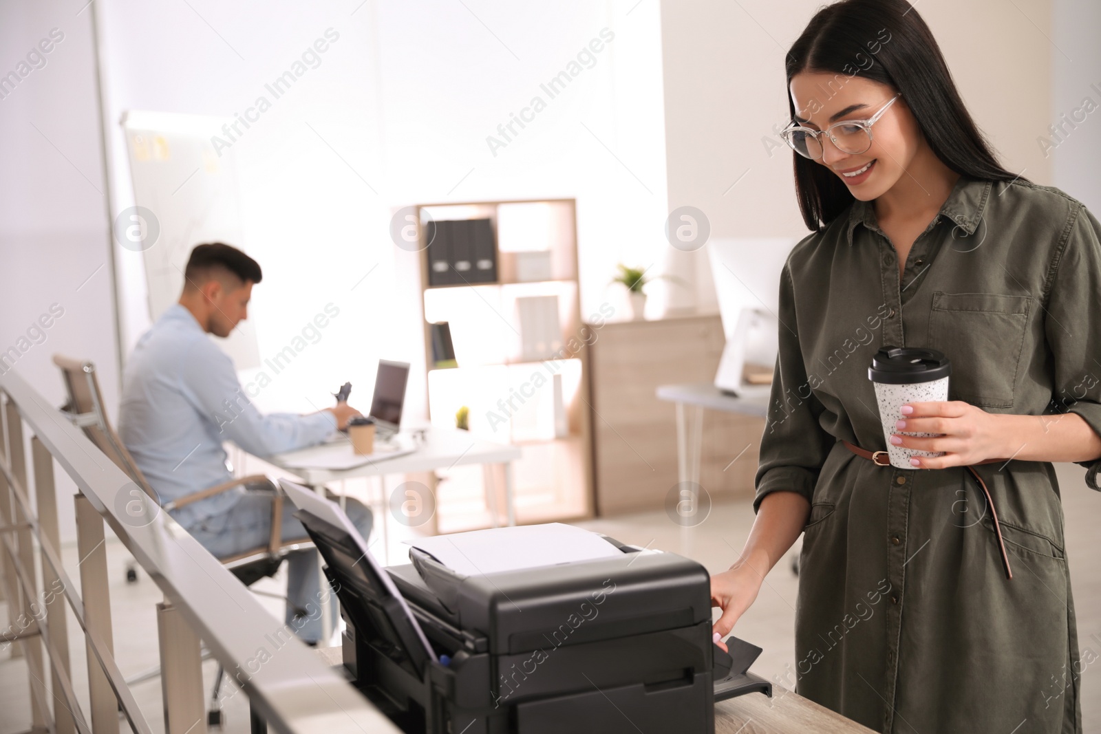 Photo of Employee using new modern printer in office