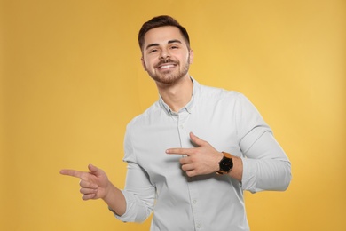 Portrait of handsome young man on color background