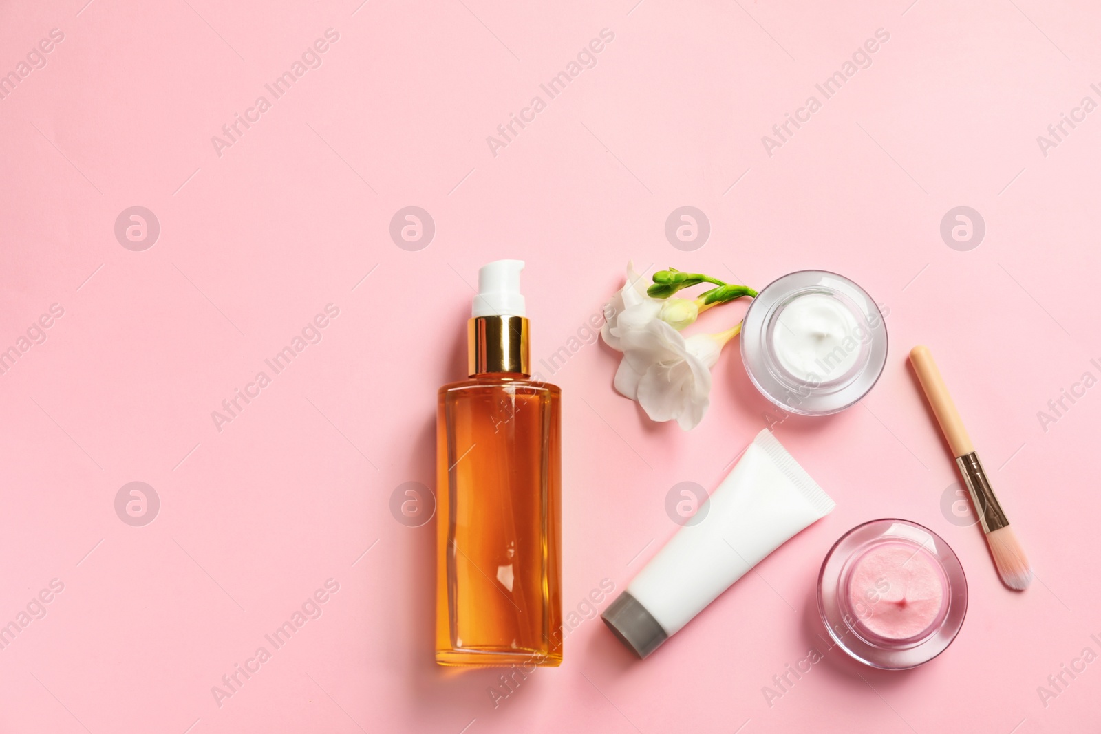 Photo of Flat lay composition with cosmetic products on color background