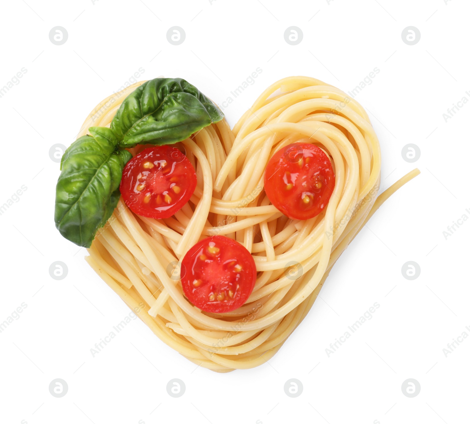 Photo of Heart made of tasty pasta, cut tomatoes and basil isolated on white