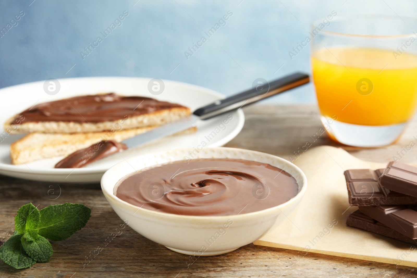 Photo of Dessert bowl with sweet chocolate mousse served on wooden table