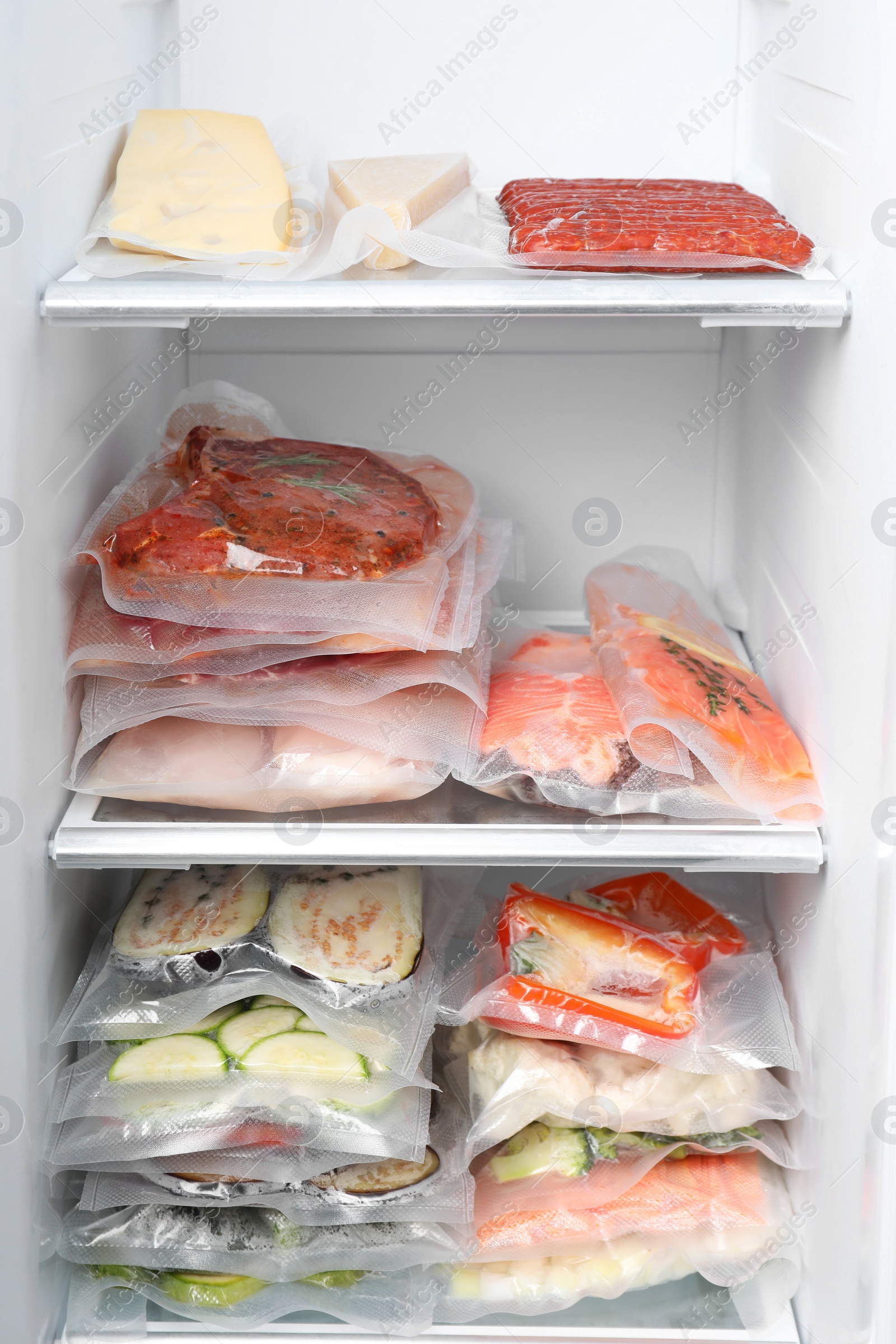 Photo of Vacuum bags with different products in fridge. Food storage