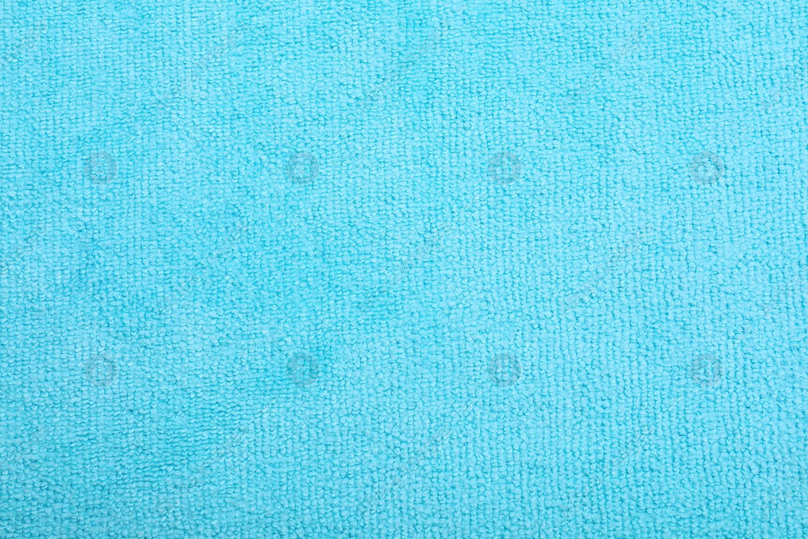 Photo of Light blue microfiber cloth as background, top view