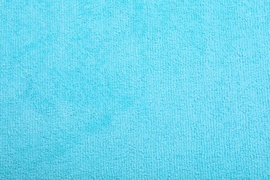 Light blue microfiber cloth as background, top view