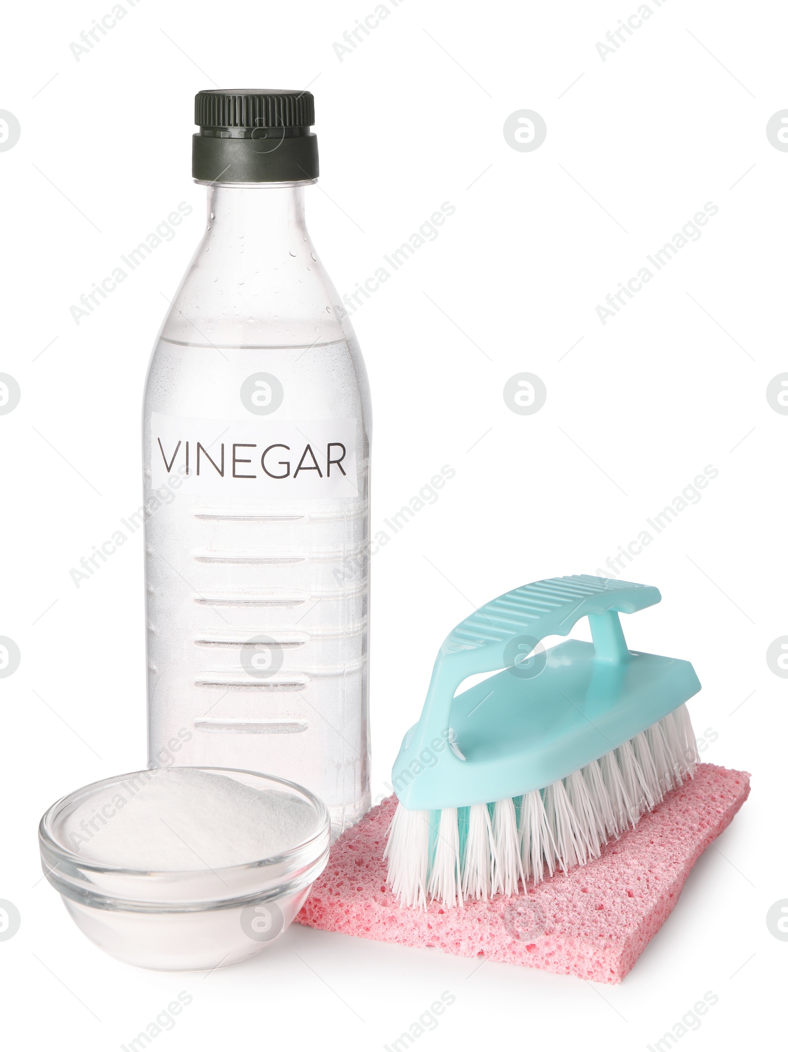 Photo of Eco friendly natural cleaners. Vinegar in bottle, sponge, brush and bowl of soda isolated on white