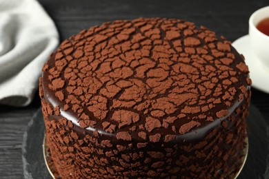 Photo of Delicious chocolate truffle cake on table, closeup