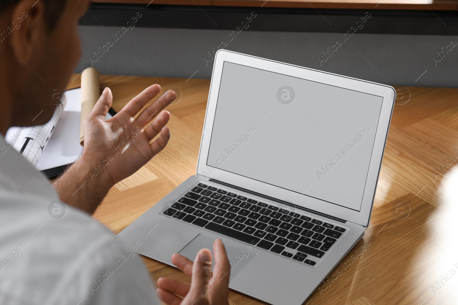 Photo of Coworkers working together online. Man using video chat on laptop, closeup