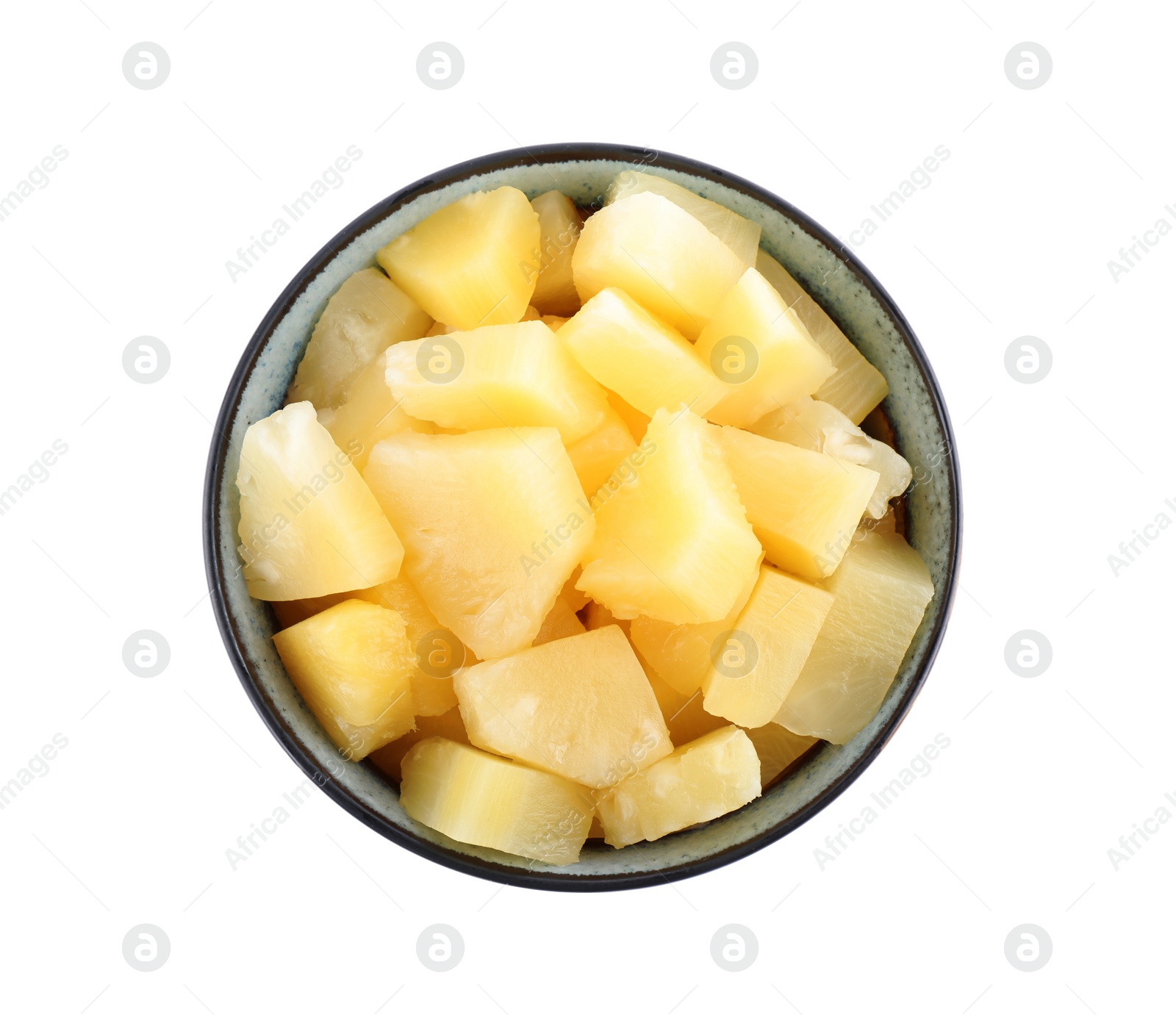 Photo of Pieces of delicious canned pineapple in bowl on white background, top view