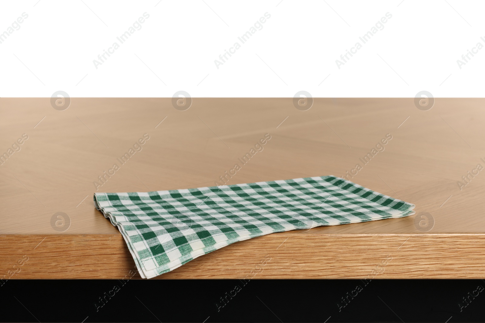 Photo of Checkered tablecloth on wooden table against white background