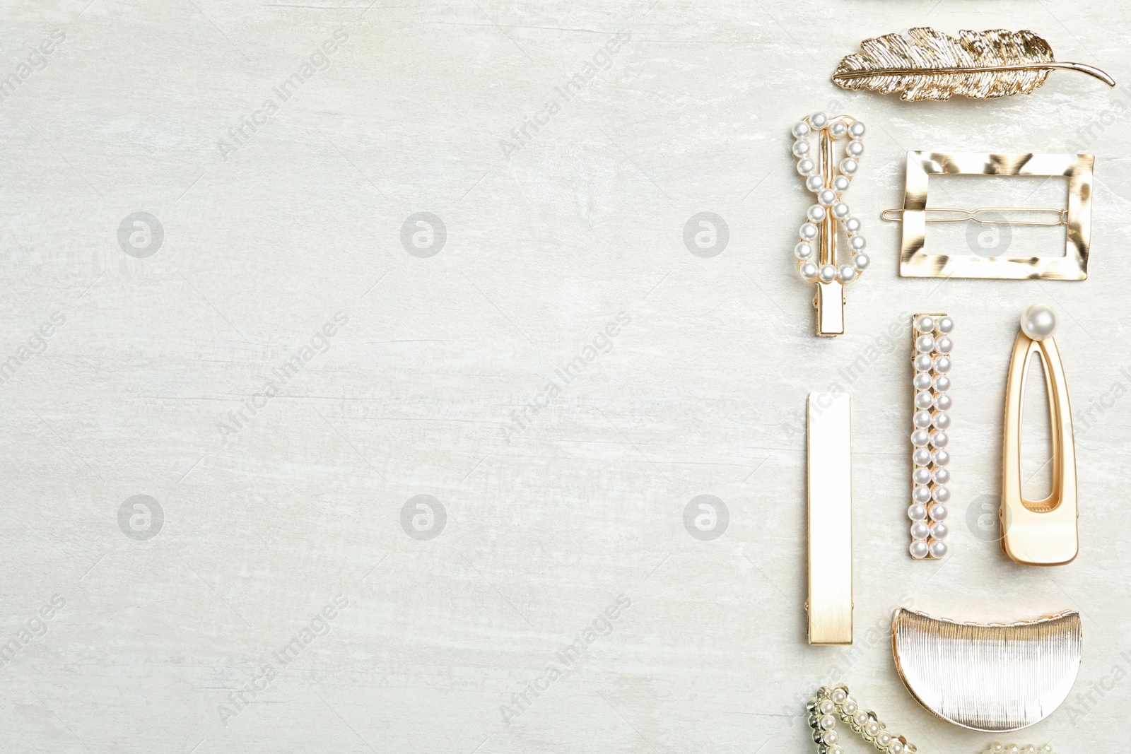 Photo of Beautiful different hair clips on white table, flat lay. Space for text