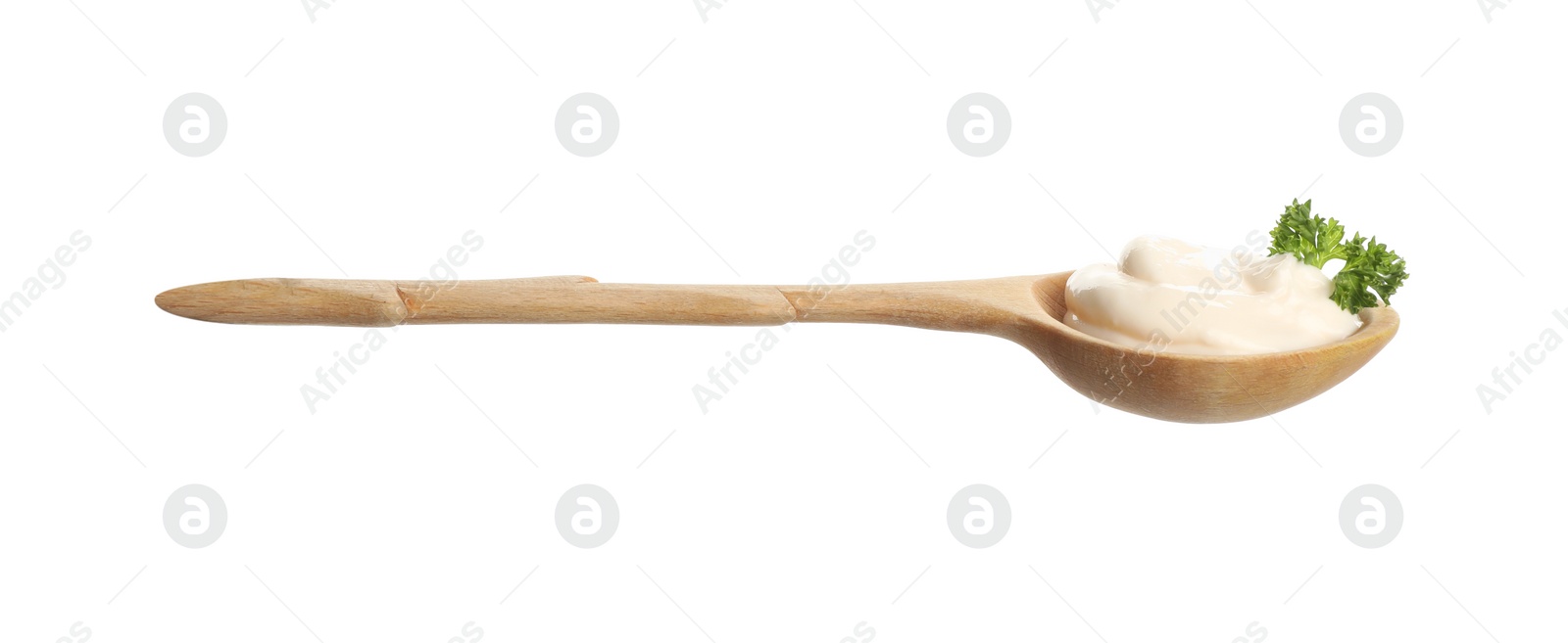 Photo of Wooden spoon with tasty mayonnaise and parsley isolated on white