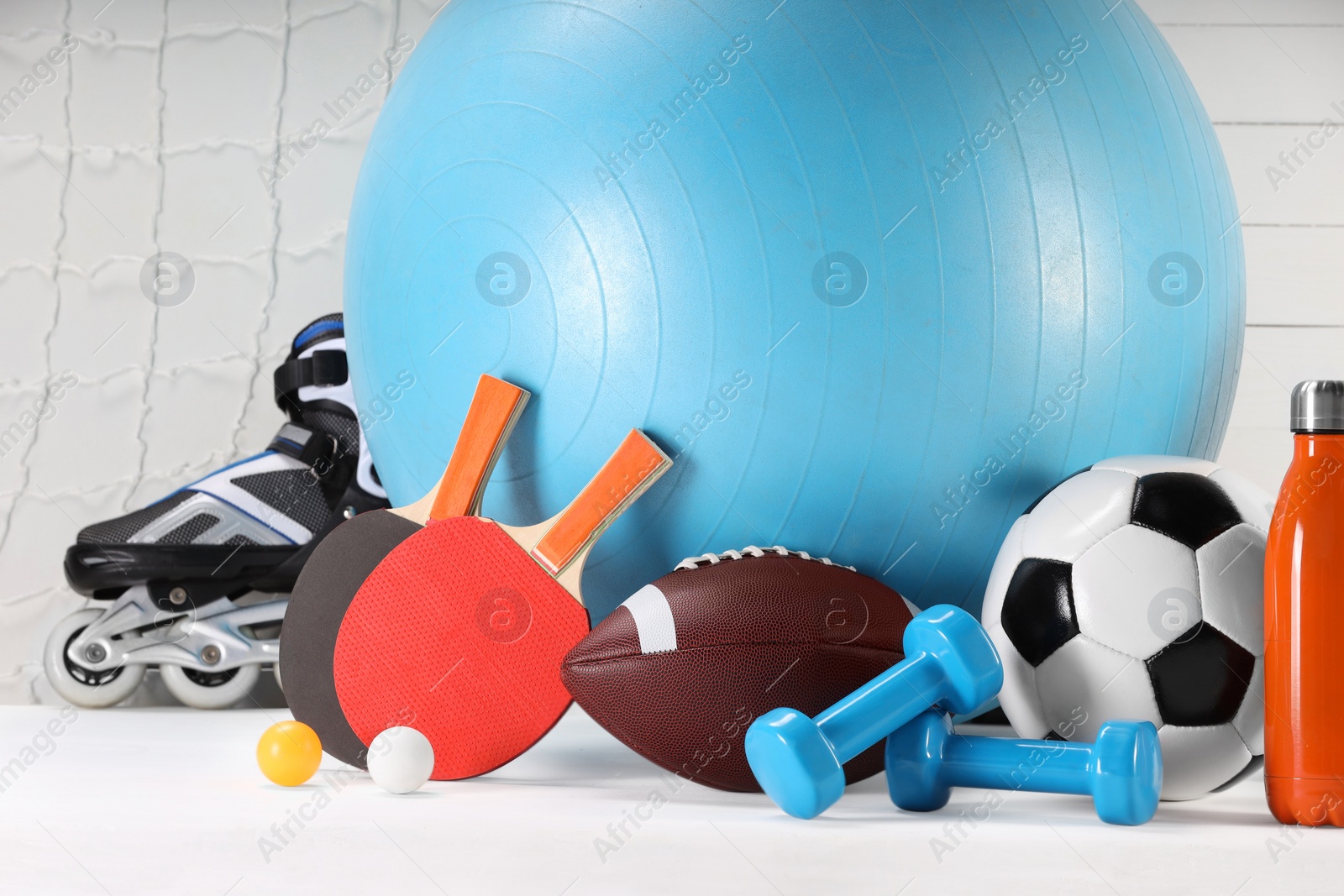 Photo of Many different sports equipment on white table