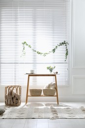 Photo of Stylish room decorated with beautiful eucalyptus garland