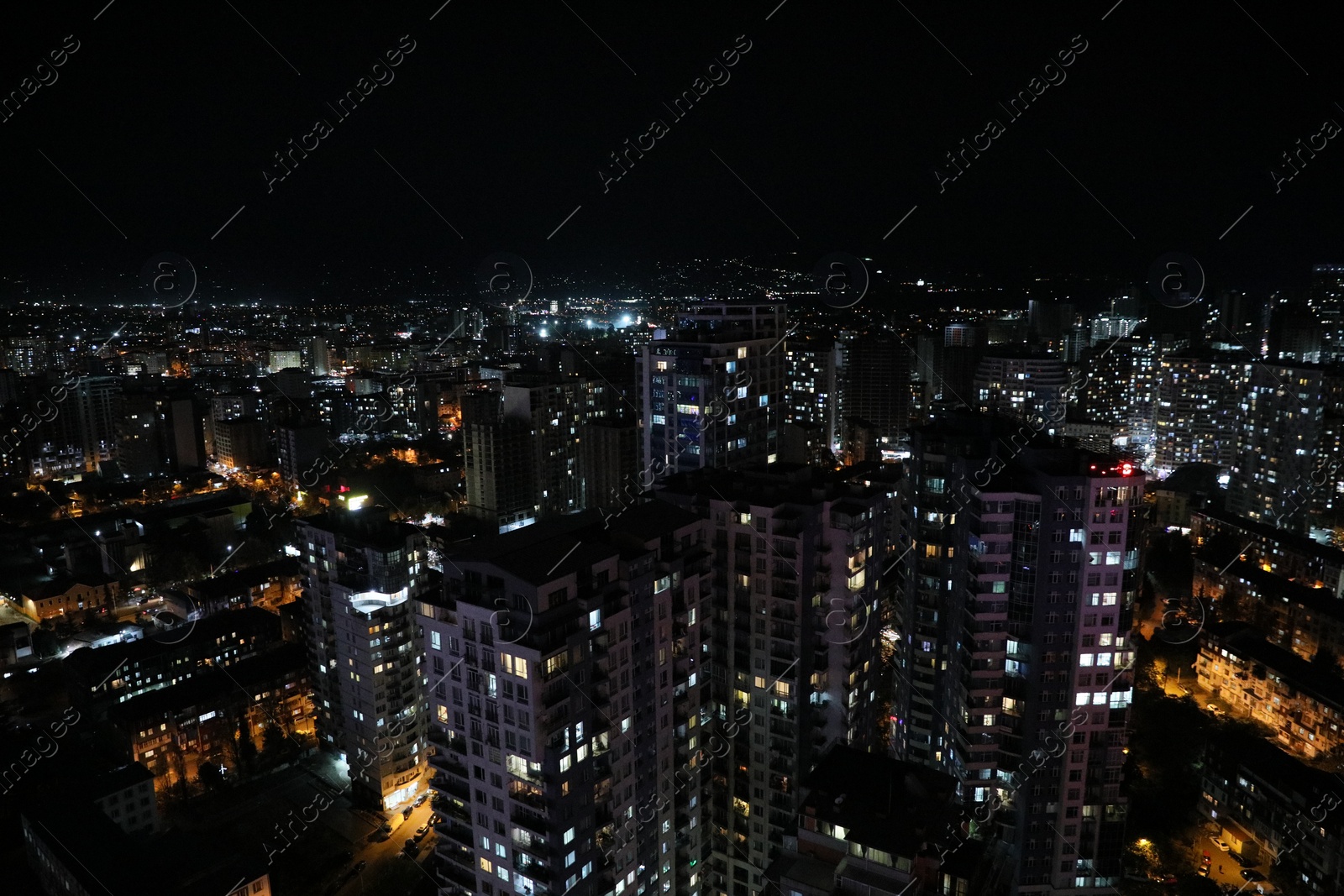 Photo of Picturesque view of city with buildings at night