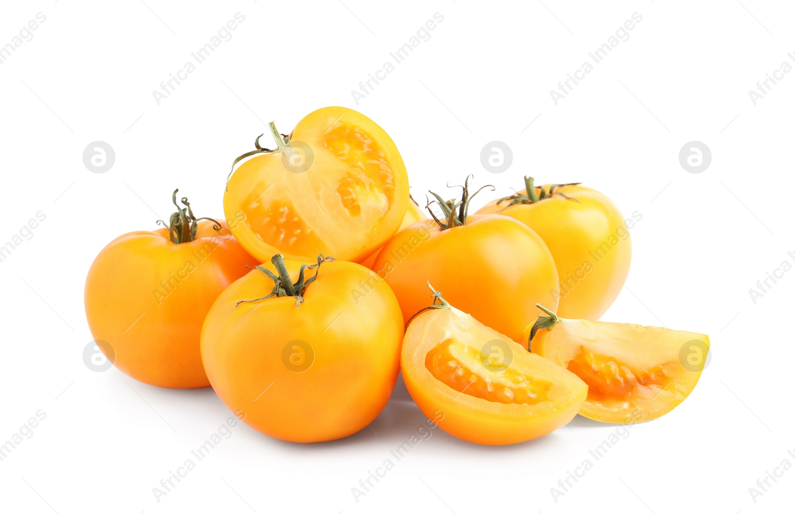 Photo of Cut and whole yellow tomatoes on white background