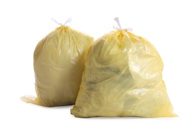 Trash bags full of garbage on white background