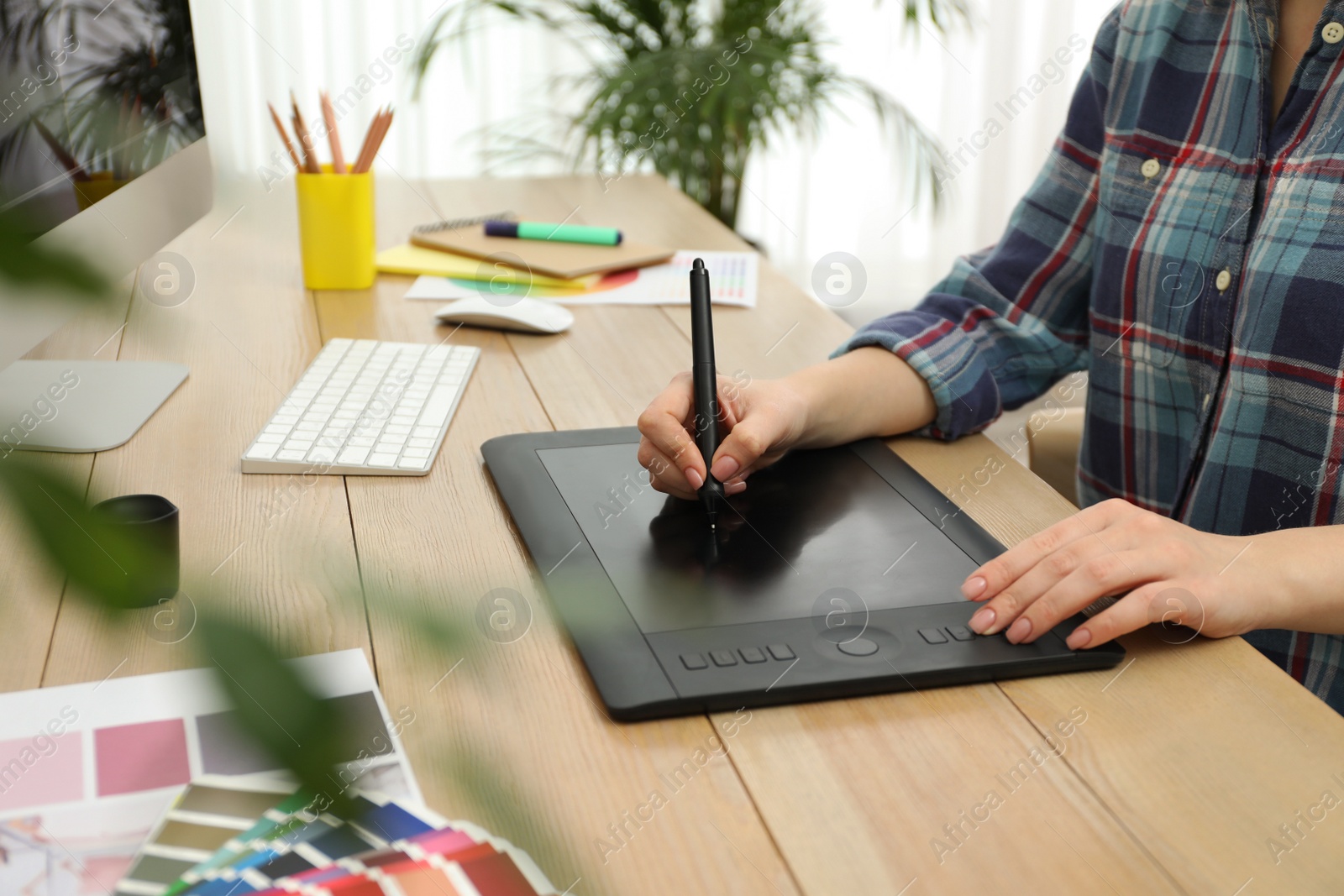 Photo of Professional designer working on graphic tablet at desk, closeup