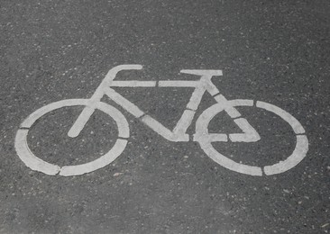 Bicycle lane with white sign painted on asphalt