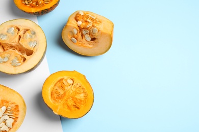 Photo of Fresh ripe pumpkins on color background, flat lay with space for text. Holiday decoration