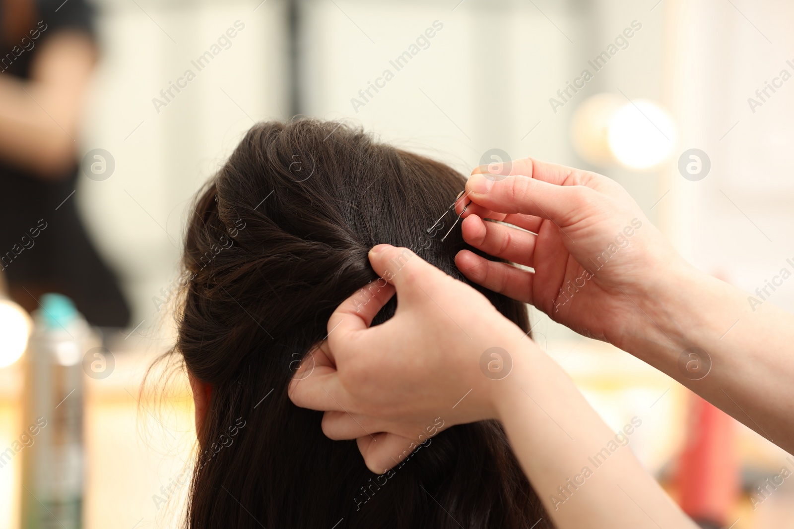 Photo of Hair styling. Professional hairdresser working with client indoors, closeup