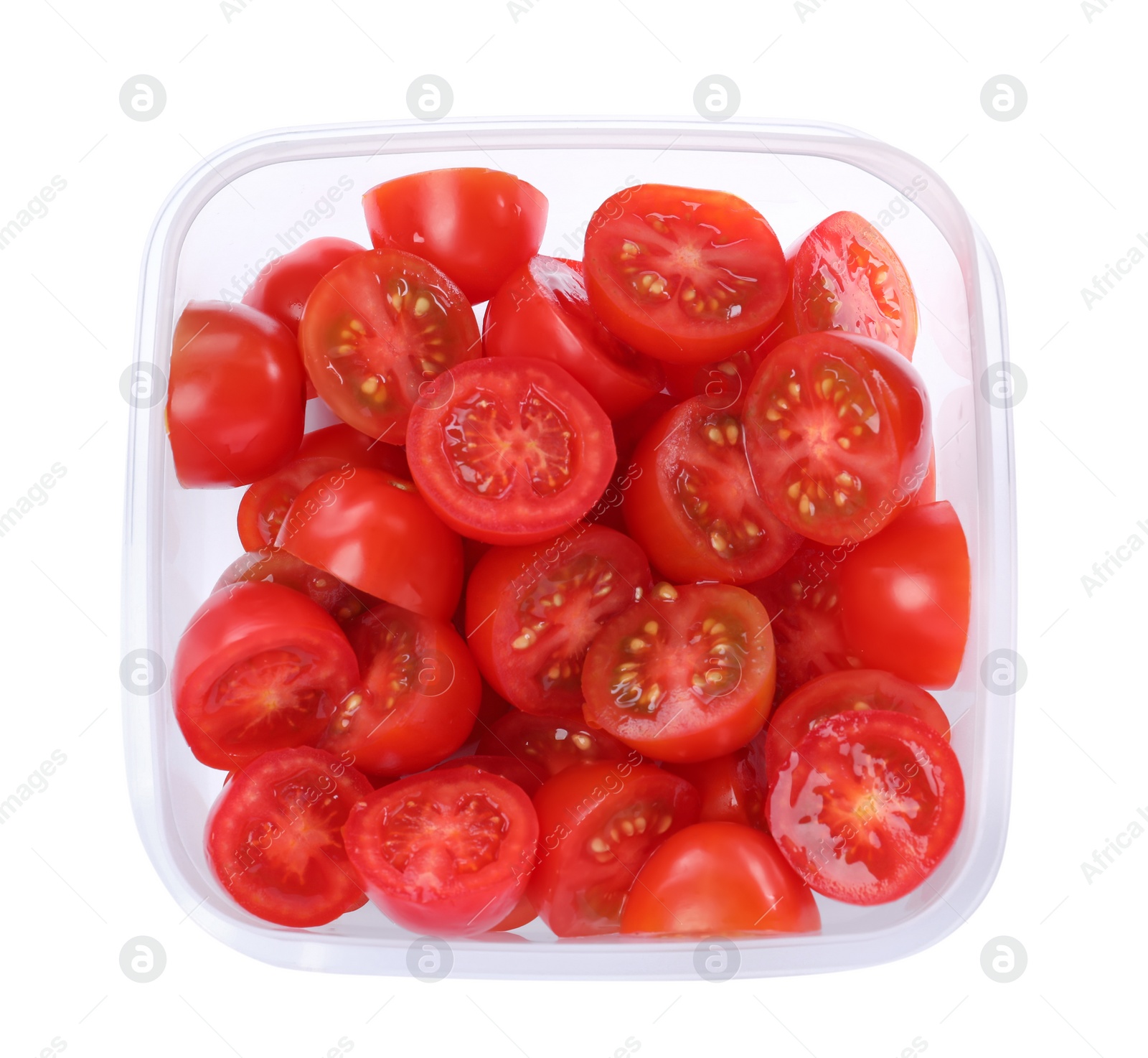 Photo of Fresh cut cherry tomatoes in plastic container isolated on white, top view